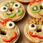 Easy Monster Bagels for Kids with fruit eyes and pretzel hair