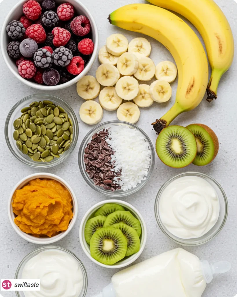 Halloween Smoothie Bowl ingredients with berries, pumpkin, yogurt, and toppings