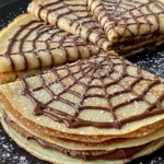 Spiderweb Crepes Treat lacy crepe webs with chocolate drizzle