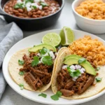 Plated Crock Pot Shredded Beef Tacos with rice and beans